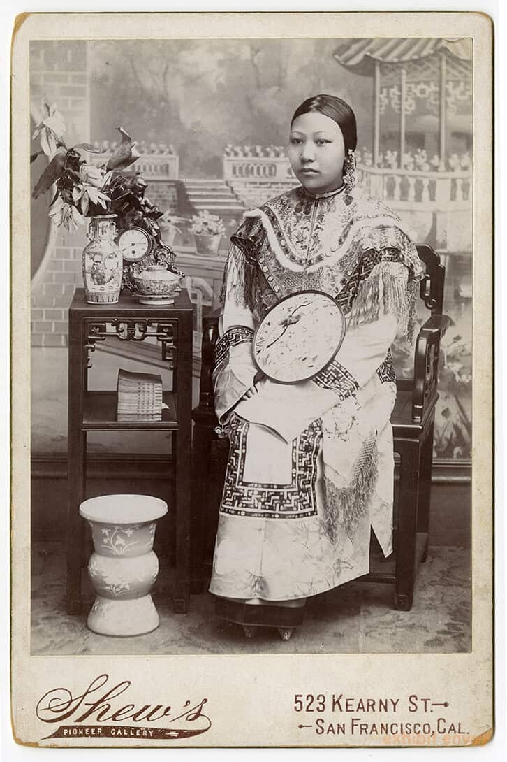 Antique photographic portrait of a Chinese-American woman, seated.