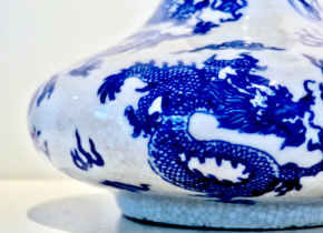 White vase with an ornate blue dragon from the collection of the San Diego Chinese Historical Museum.