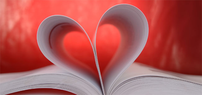 Pages of an open book, curved to form the shape of a heart.  