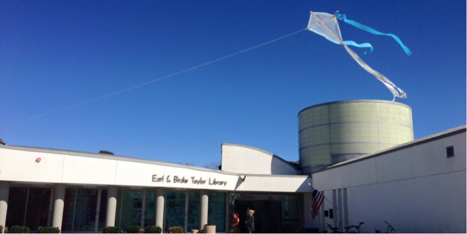 A kite flying above the PB Library