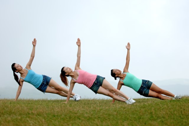 three women in a yoga pose