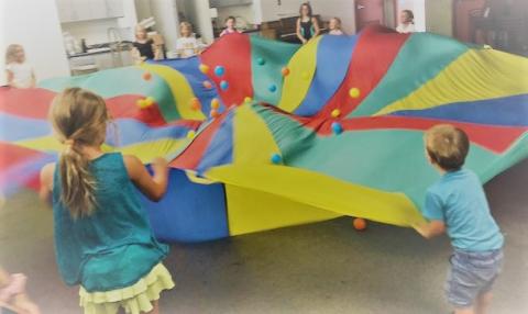 Children playing with parachute