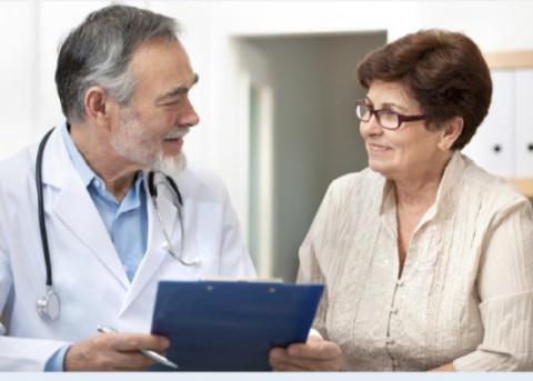 Male doctor speaking with a female patient