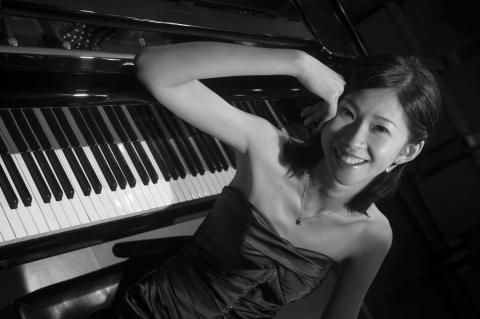 Amber Liao next to piano keyboard