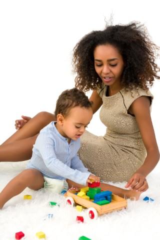 Mother plays Legos with son
