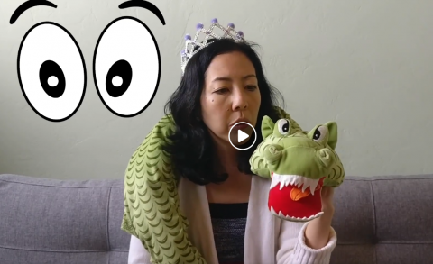 Photo of librarian with stuffed animal dragon