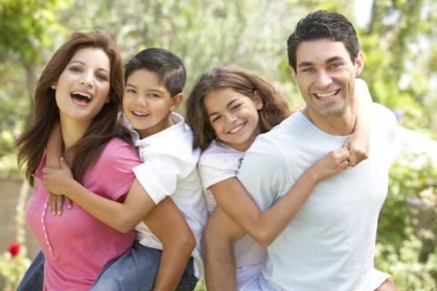 two adults with young children on their backs