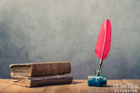 Books and quill pen in inkwell