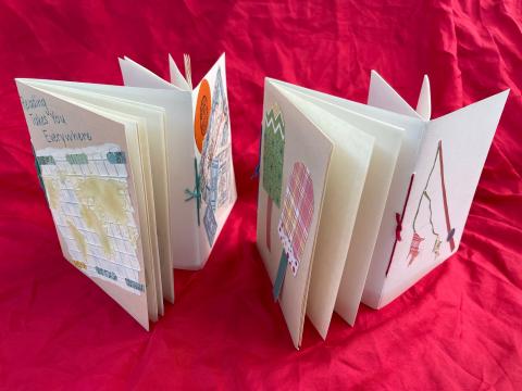 Two handmade books that each have two components, such that two books are linked together in opposite directions