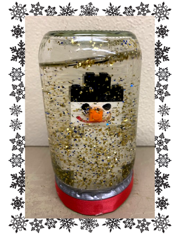 Glass jar snow globe with Lego snowman inside