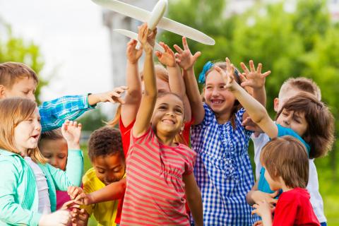 Children playing with toy plane.