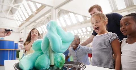 Children watching a chemical reaction know as "elephant's toothpaste"