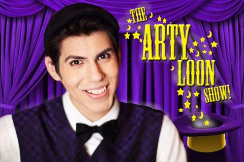 Arty Loon standing in front of a purple curtain wearing a vest and bowtie