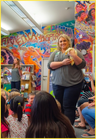 Presenter showing a duck to children in the library