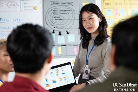 Teacher showing students something on tablet screen