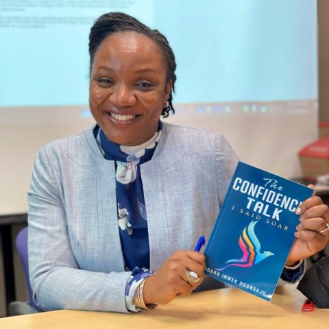 Portrait of Idara Inwek Ogunsaju holding her book The Confidence Talk
