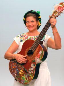 Georgette Baker with a guitar