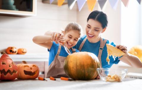 Family carving a pumpkin