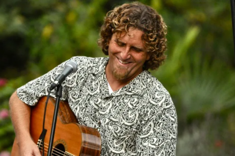 Musician Steve Denys from Hullabaloo playing his guitar