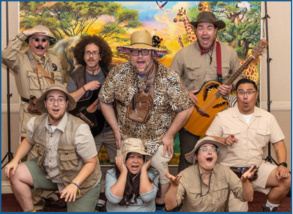SDSU Performing Arts troupe wearing safari clothes, holding instruments, and looking excited or amazed