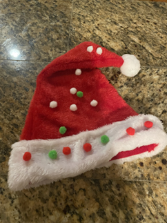 red santa hat decorated with colorful sequins