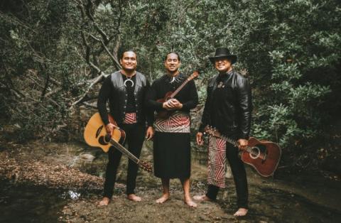 Image of the three Faiva ensemble members outside with instruments