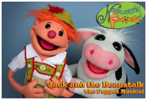 Two puppets smiling: one is a young boy with red hair and the other is a friendly cow.