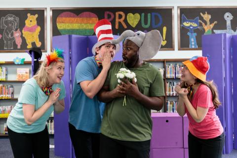 Four actors in Dr. Seuss costumes performing at a library.