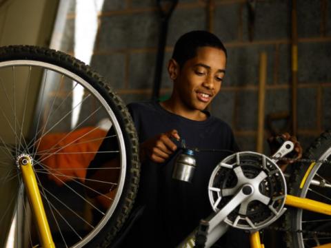 Teen repairing bicycle
