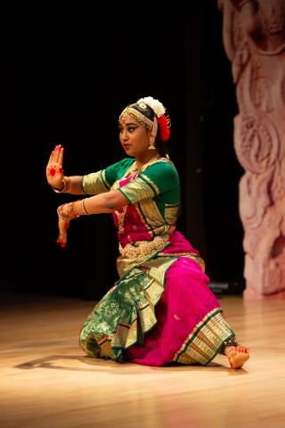 Kuchipudi dancer in green, gold, and pink costume