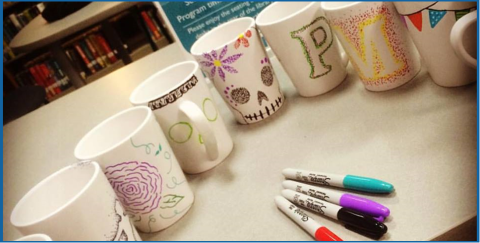 A group of mugs with pens next to them