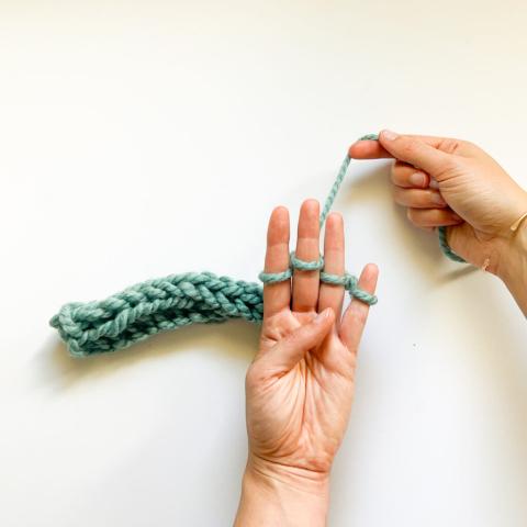 Image of hands creating a finger knitting project