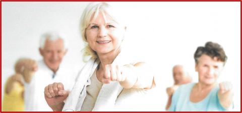 A group of older adults putting their fists up in a defensive position.