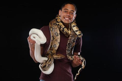 Wild Man Dan holding 2 snakes