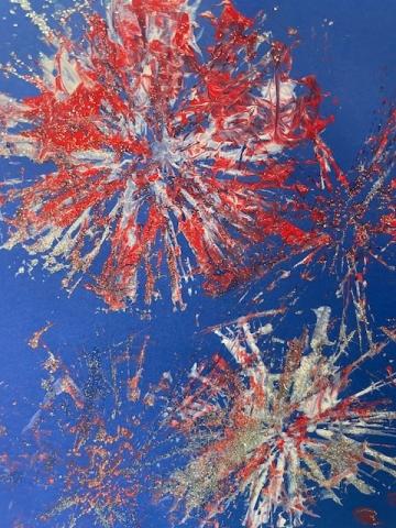 fireworks images painted with red and white paint on blue paper
