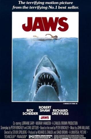 Jaws movie poster with Jaws at the top in large red text, and a large great white shark swimming to the surface of the ocean