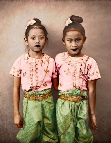 Photographic portrait of two young girls in traditional Cambodian clothes by artist John Raymond Mireles.
