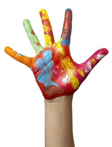 Child's hand with palm and fingers covered in multi-colored paint