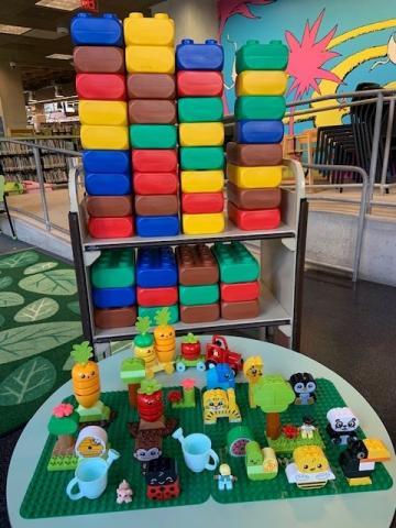 Lego Duplos displayed on table and cart of giant lego bricks!