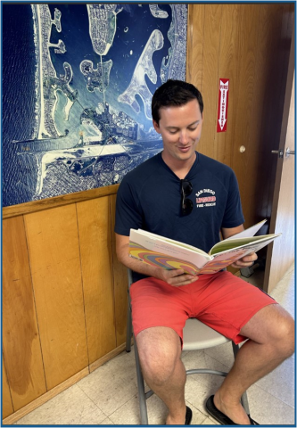 Lifeguard reading a book