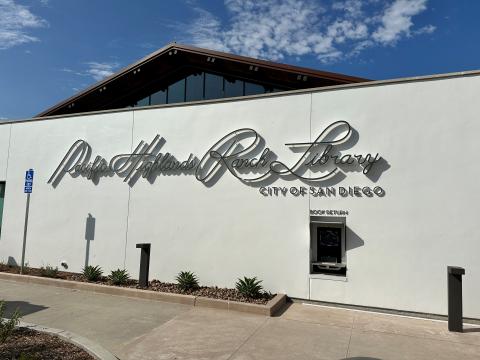 Front of library building with Pacific Highlands Ranch Library sign shown prominently