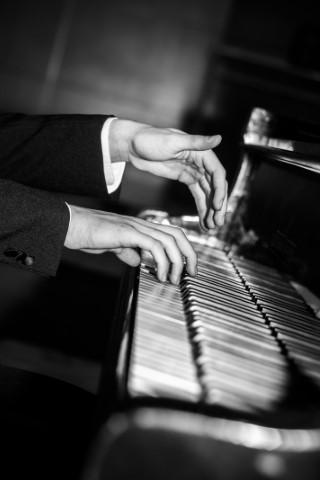 Hands playing on piano