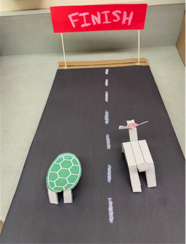 Tortoise and hare paper animals competing in a race