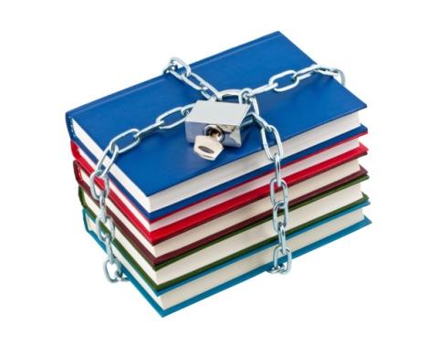 stack of books in chains and padlock