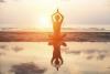 Woman doing a yoga pose on the beach