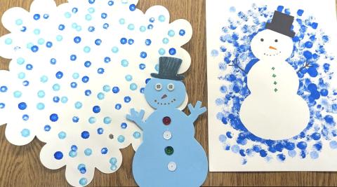 Snowman made of paper, painted snowman, and painted snowflake decoration.