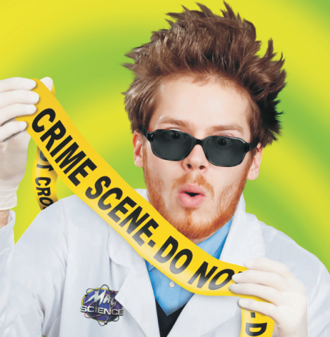 Scientist in White Lab Coat wears black sunglasses and holds up a yellow caution tape sign, against a yellow and green neon background. 