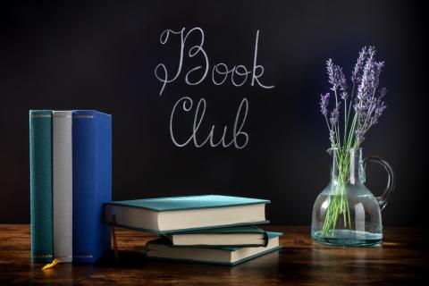 image of books and flowers on a table with the words "book club"