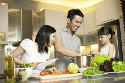 Family at counter preparing a meal