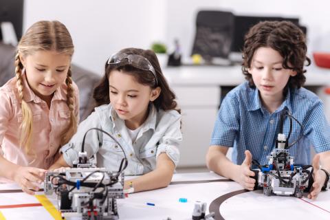 Three children with robotic machines 